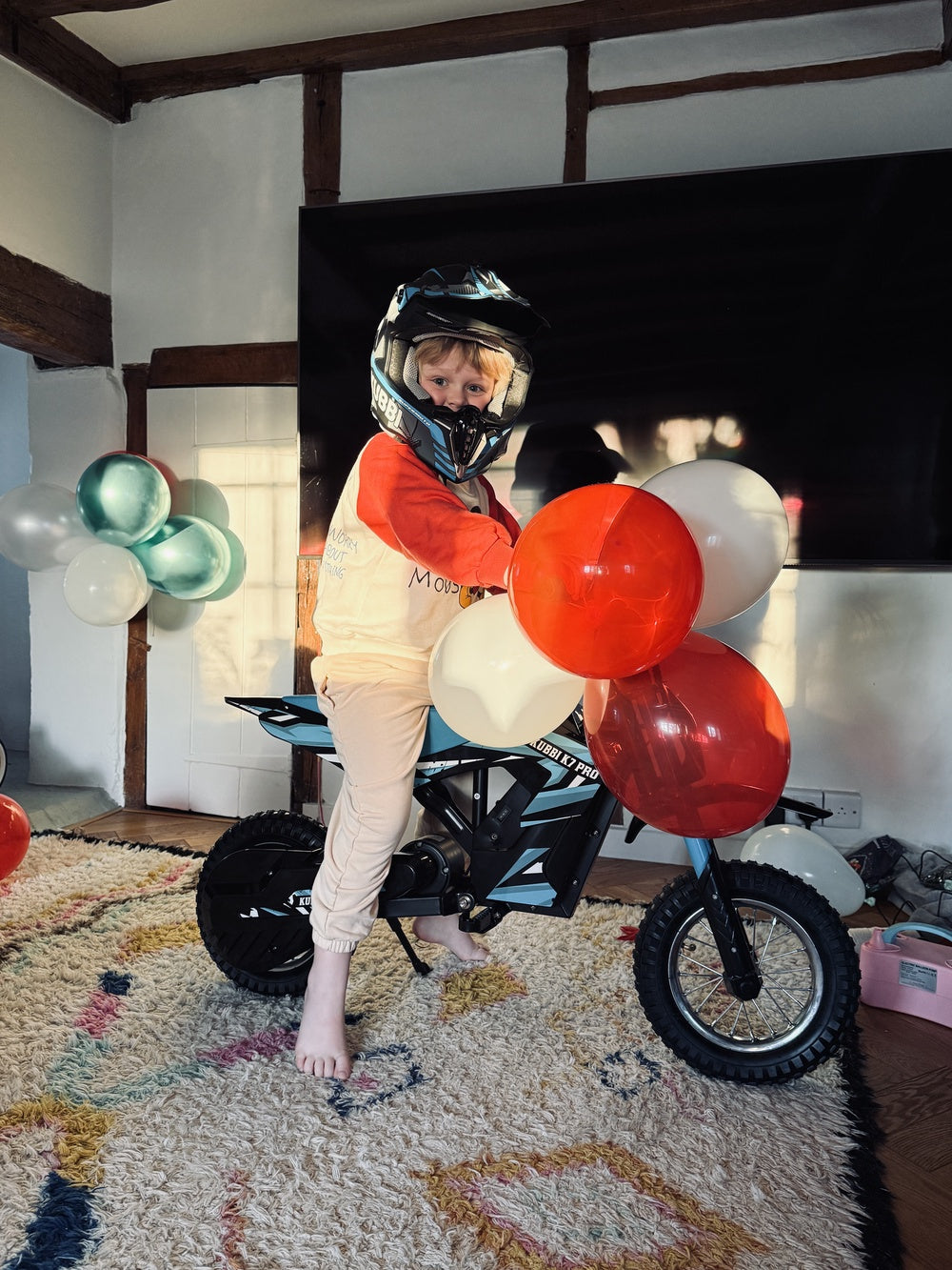 Child opening a Kubbi electric dirt bike for Christmas in the UK