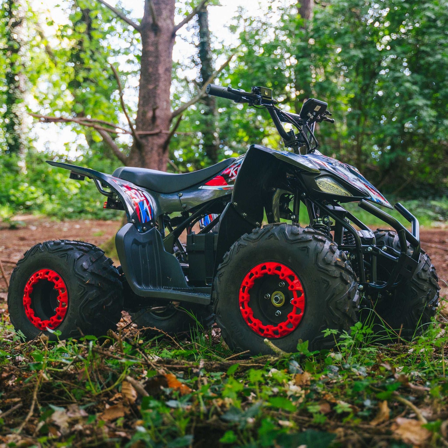 Kubbi Q32 electric quad bike in red with black accents for teens aged 14-18 powered by 2500W motor on dirt trail