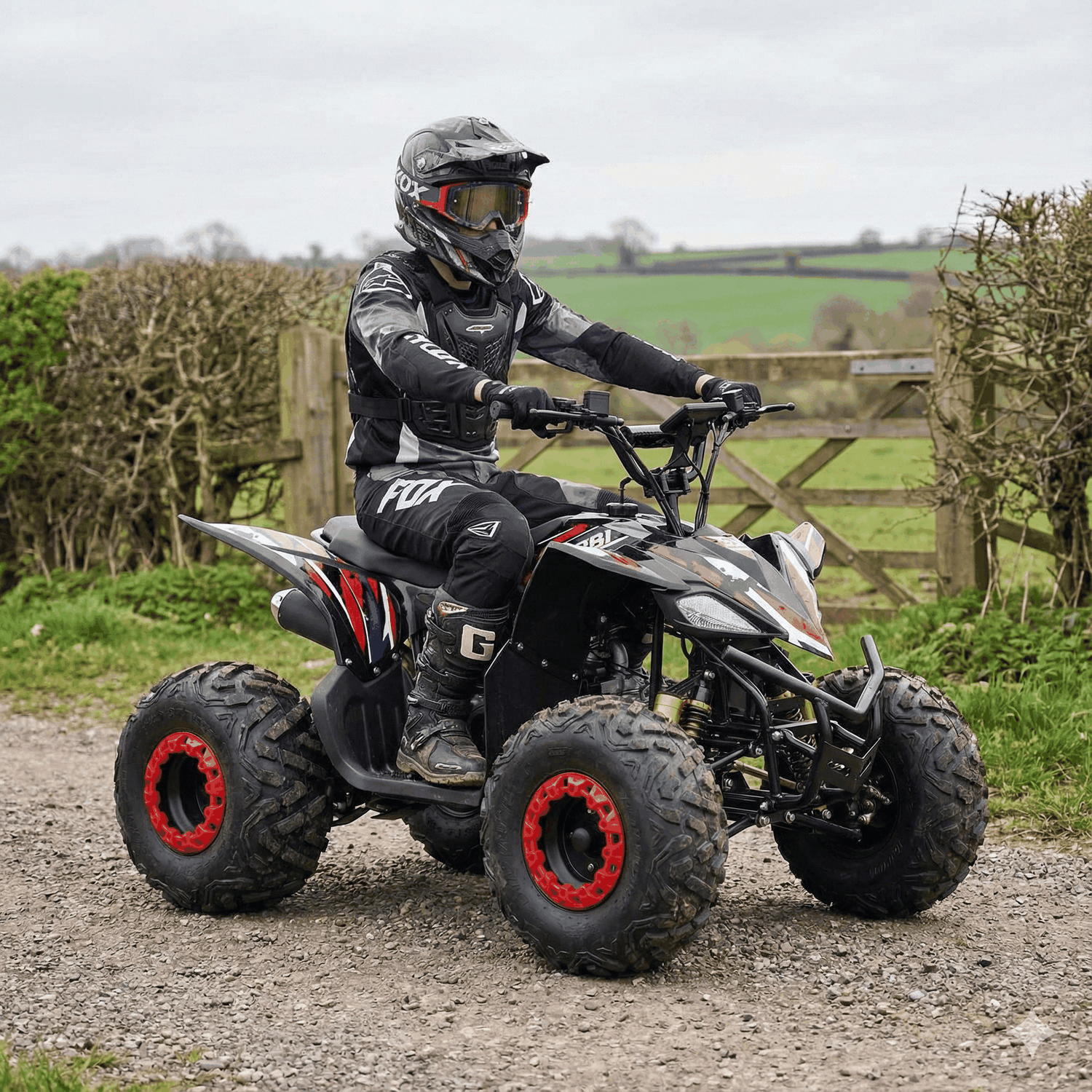Teen riding a Kubbi Q32 Quad electric quad bike on a dirt path outdoors