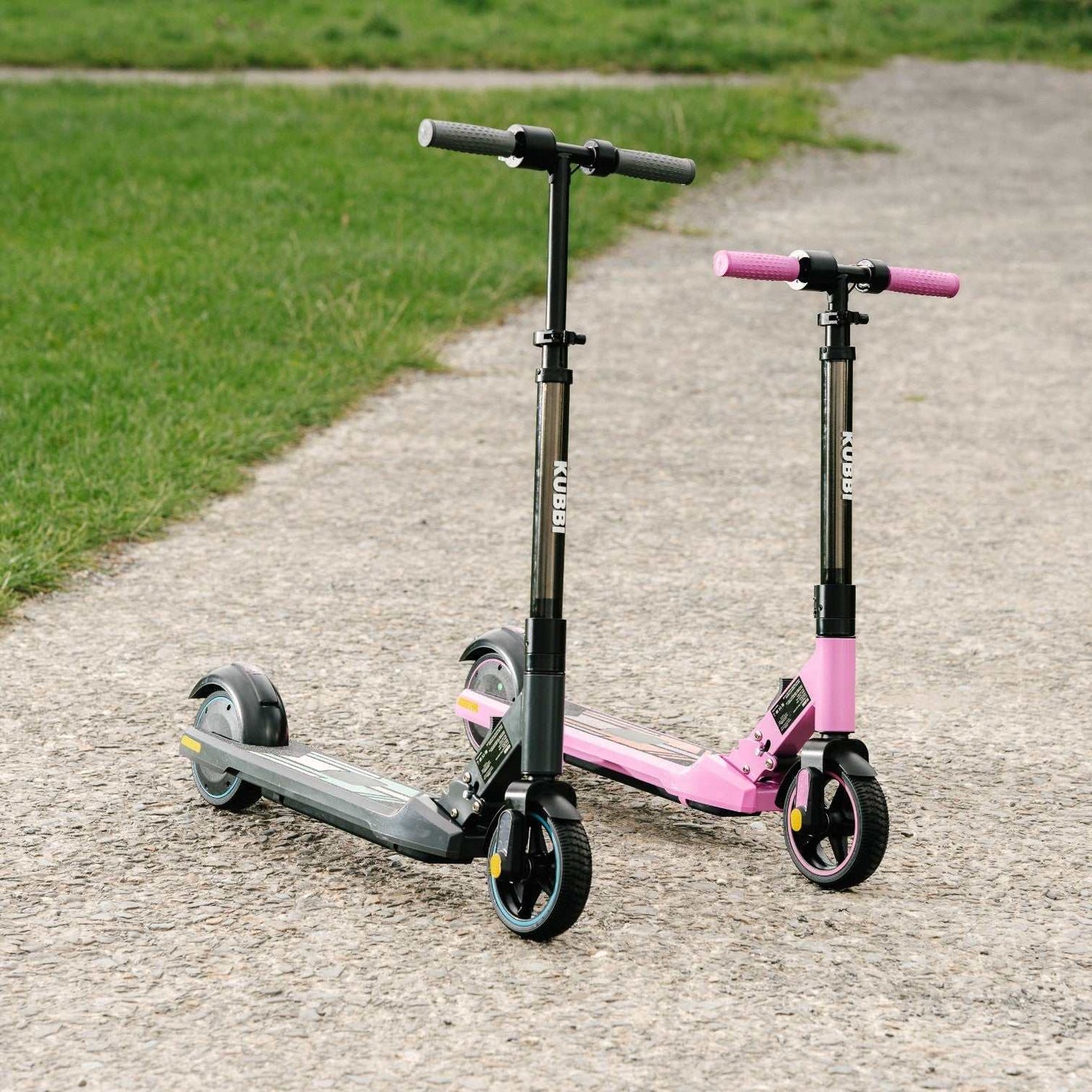 Two Kubbi S9 Pro electric scooters in black and pink on a paved path near grass