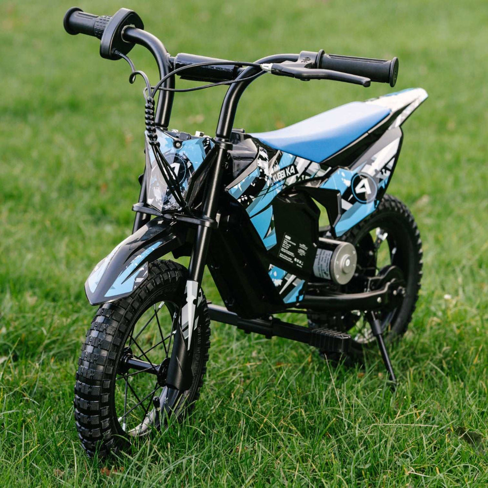 Kubbi K4 Dirt Bike kids electric blue and black off-road bike on grass with 12-inch tires