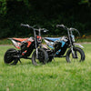 Kubbi K4 Dirt Bike kids electric dirt bikes in red and blue with 12-inch off-road tires on grass