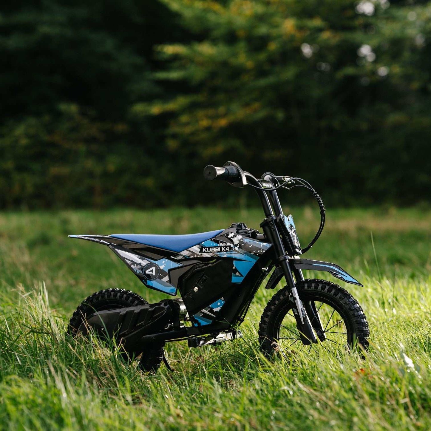Kubbi K4 Dirt Bike kids electric off-road bike with 12-inch tires and 150W motor in grassy outdoor setting