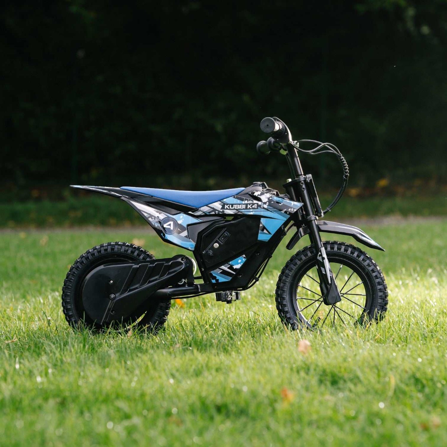 Kubbi K4 Dirt Bike electric kids bike with 12-inch off-road tires and 150W motor on grass background