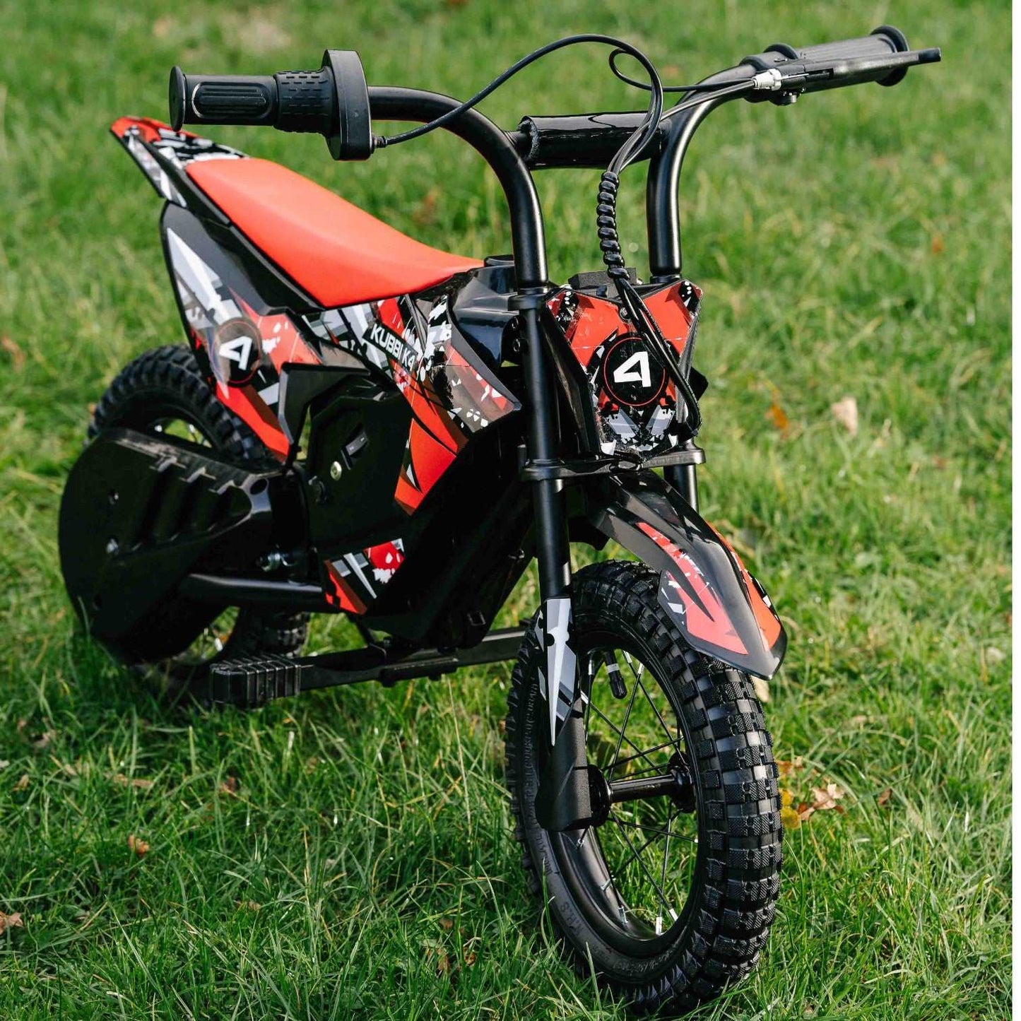 Kubbi K4 Dirt Bike red and black electric kids off-road bike on grass with 12-inch tires