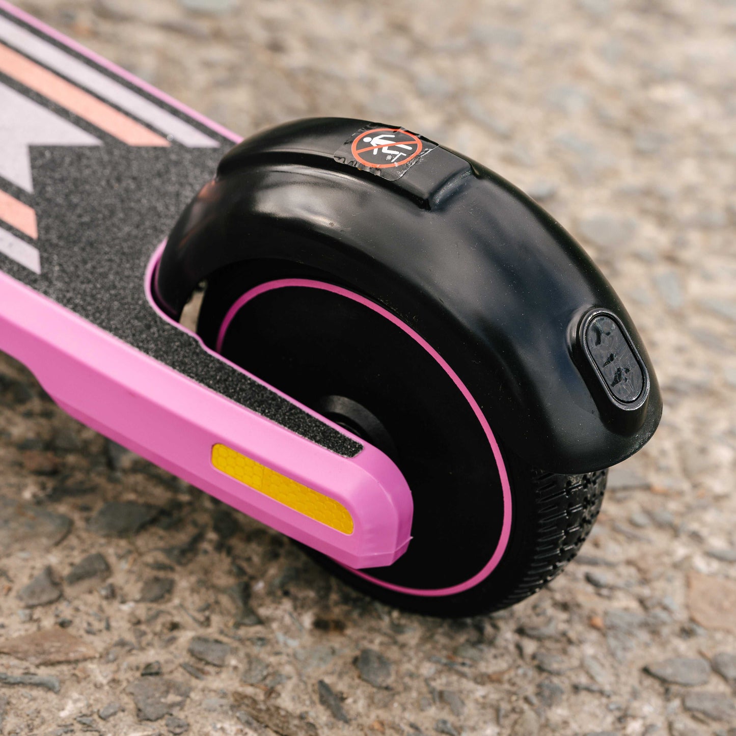 Close-up of Kubbi S9 Pro electric scooter rear wheel with pink and black design on asphalt surface