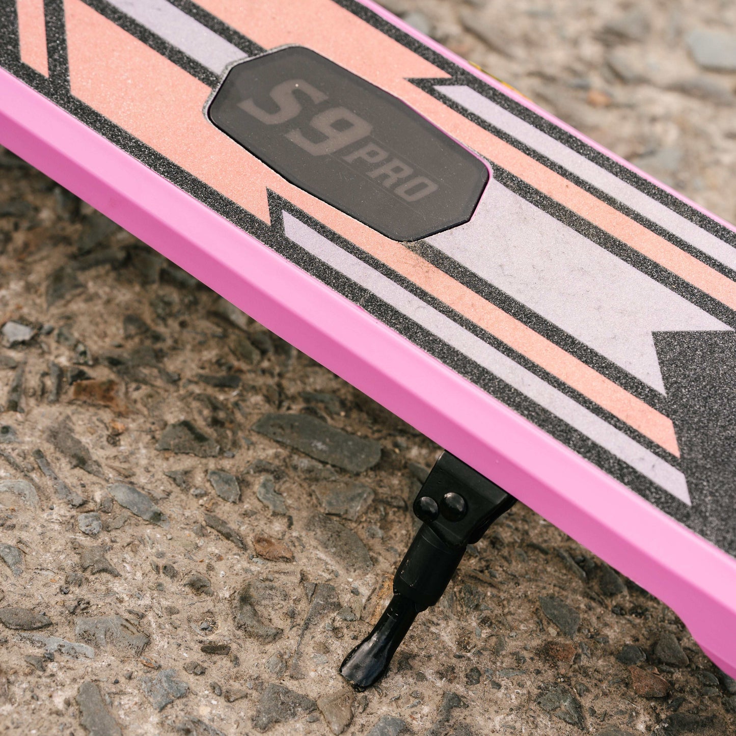 Close-up of Kubbi S9 Pro electric scooter deck and kickstand on pavement