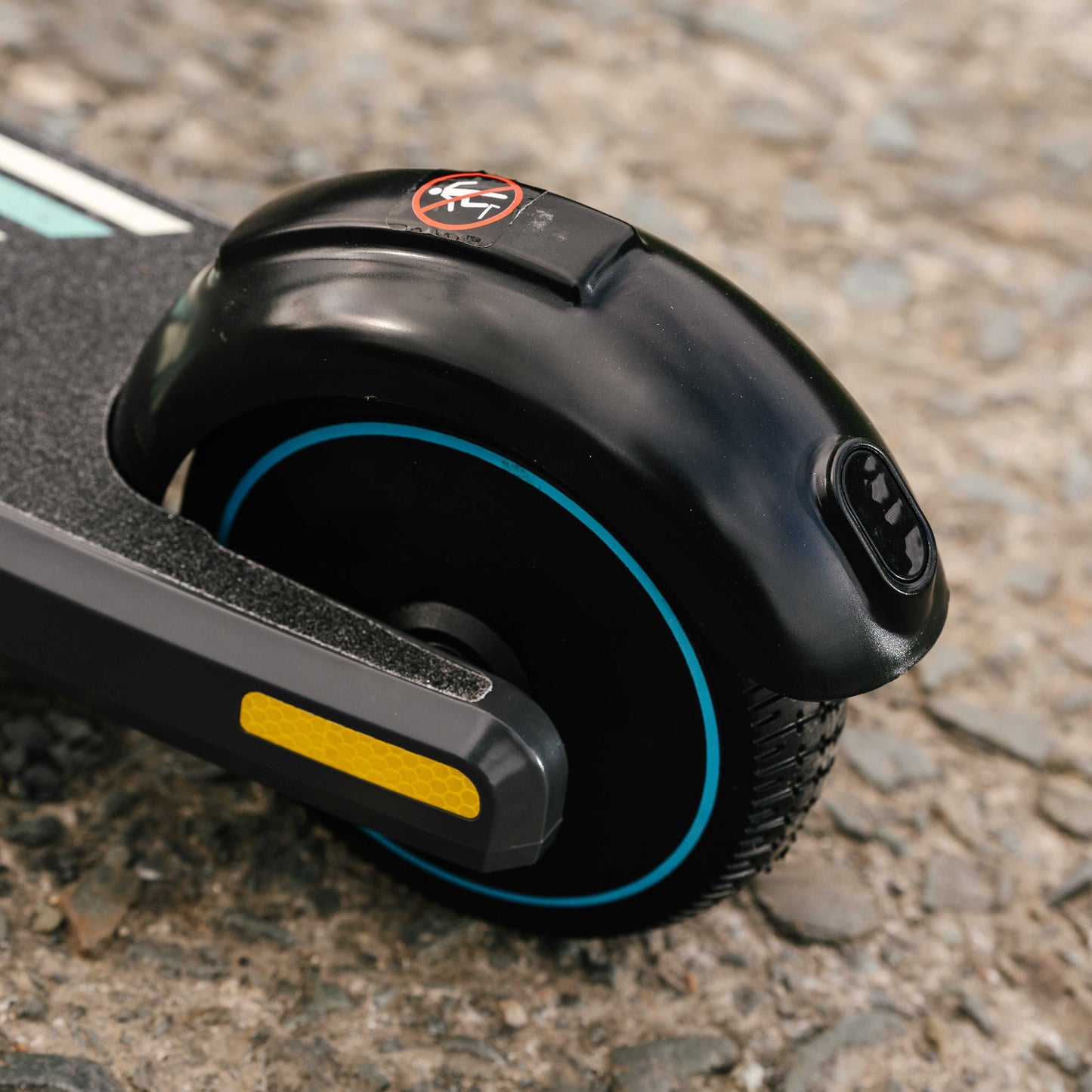 Close-up of Kubbi S9 Pro electric scooter rear wheel with durable black tire and blue accent on pavement