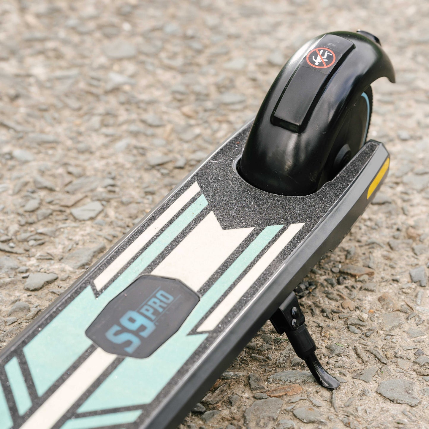 Kubbi S9 Pro electric scooter deck and rear wheel on pavement with kickstand deployed