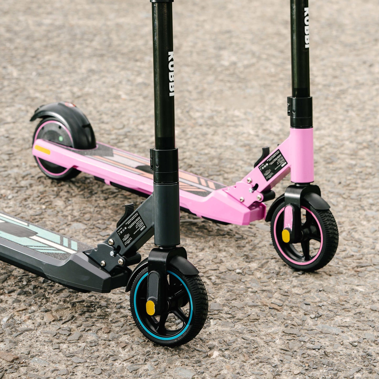 Kubbi S9 Pro electric scooters in pink and black with durable wheels on pavement surface