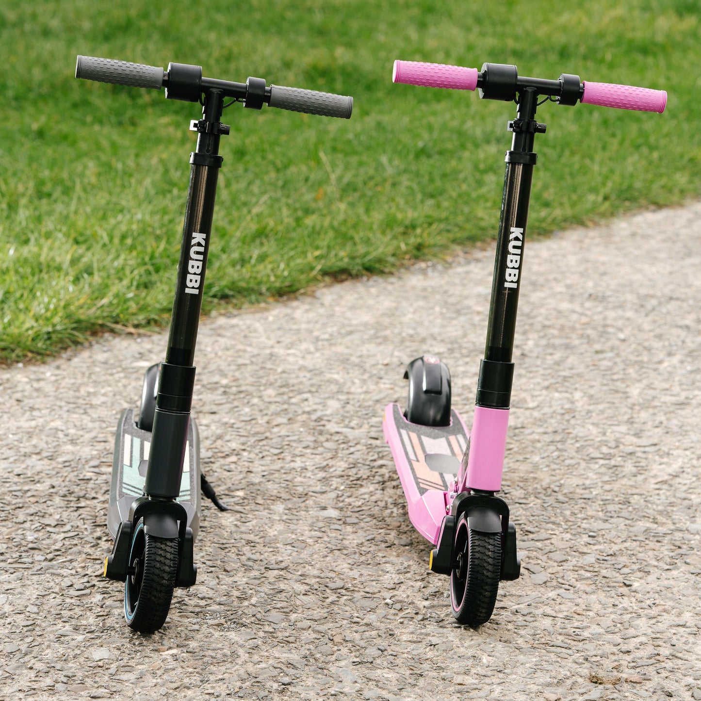 Kubbi S9 Pro electric scooters in black and pink on a paved pathway with grass background