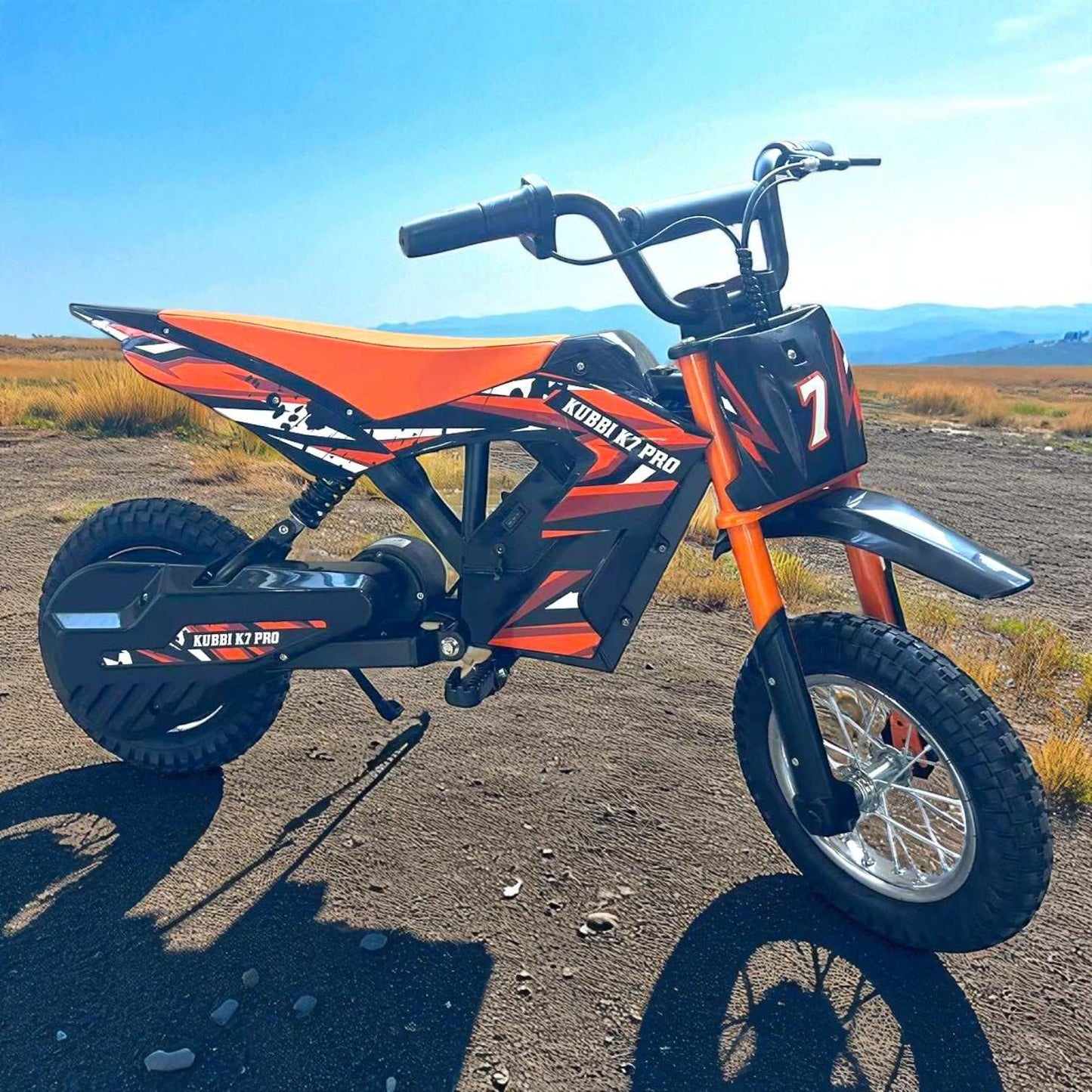 Kubbi K7 Pro Kids electric dirt bike in orange and black with 12-inch off-road tires, designed for ages 5 to 13.